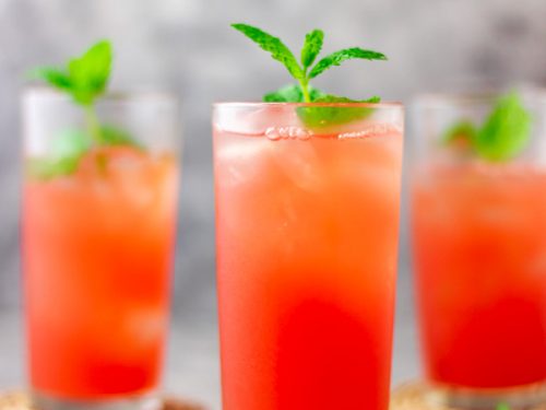 3 glasses filled with watermelon lemonade.