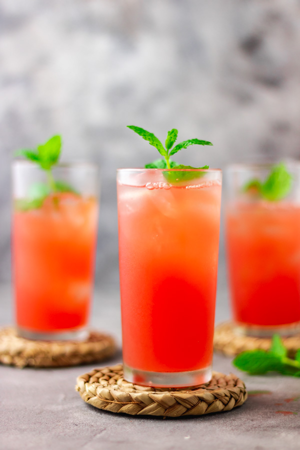 3 glasses filled with watermelon lemonade.