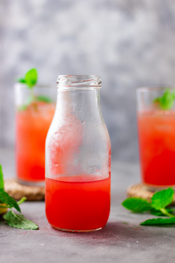 overhead shot of iced watermelon lemonade garnished with mint leaves.