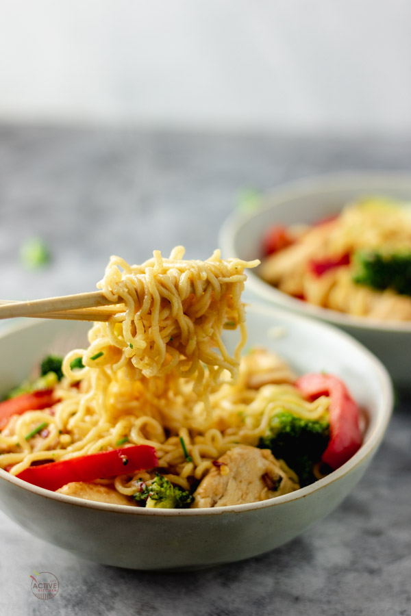 ramen noodle stir fry on a chop stick.