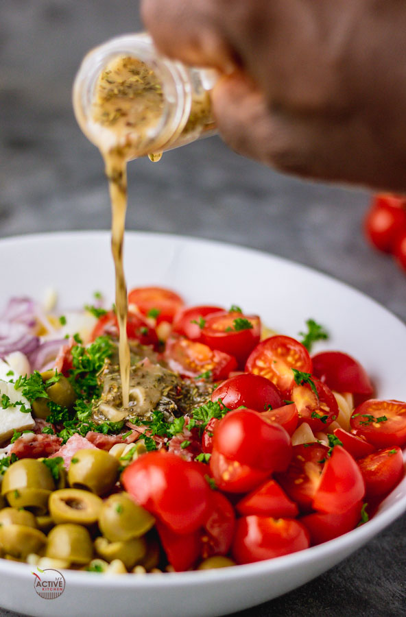 pour shout of homemade Italian dressing over pasta salad.