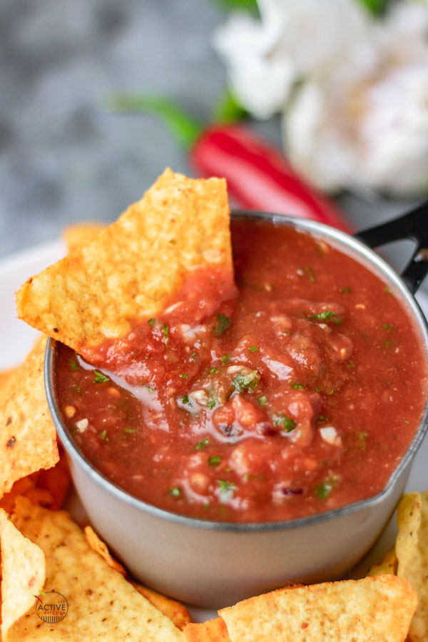 corn chip dipped in a bowl of homemade blender salsa.