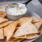 baked flour tortilla chips with a side dip.