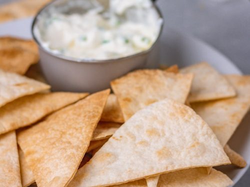 baked flour tortilla chips with a side dip.