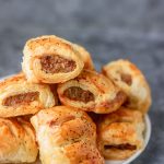 stack of mini sausage rolls in a white plate.