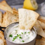 baked flour tortilla chip in a sour cream and chive dip.