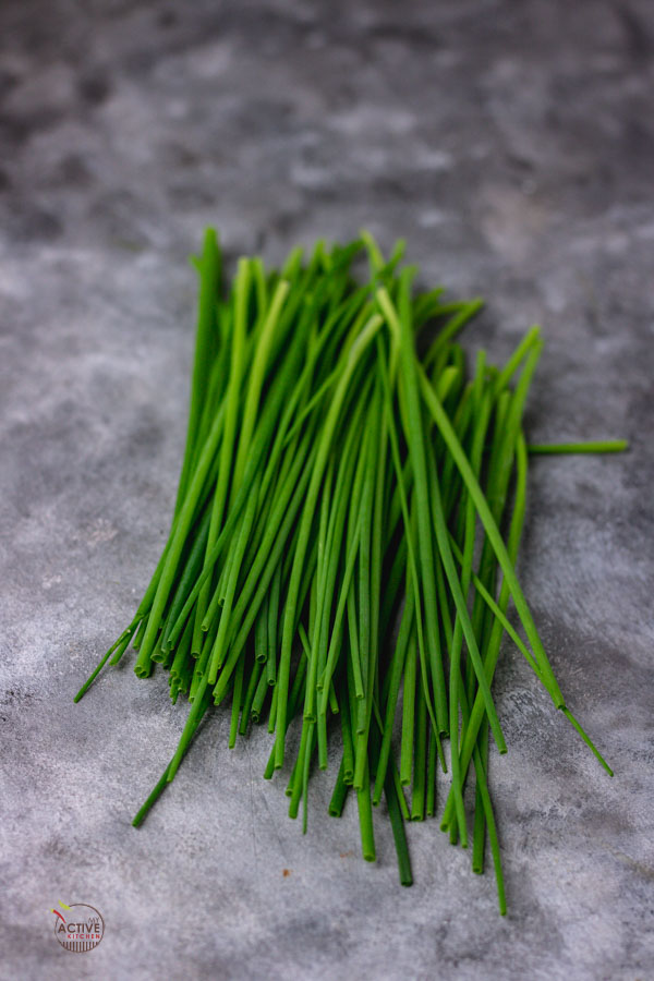 loose chives on a blue hue surface.