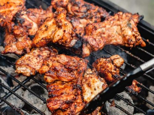 grilled boneless chicken thighs on a barbecue.