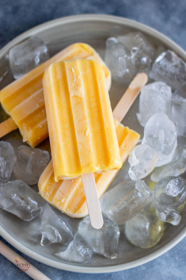 mango Popsicle and ice on a grey plate. 