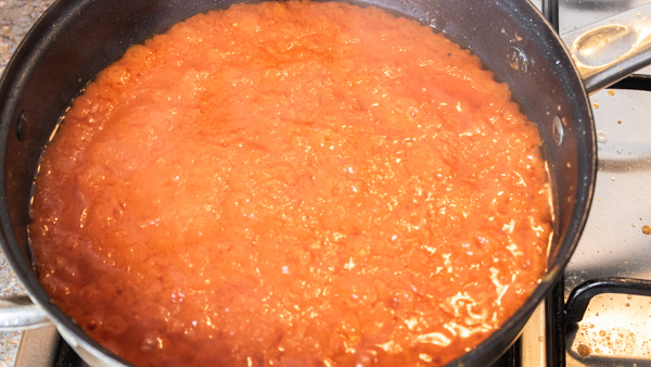 cooking pepper in pan over heat.