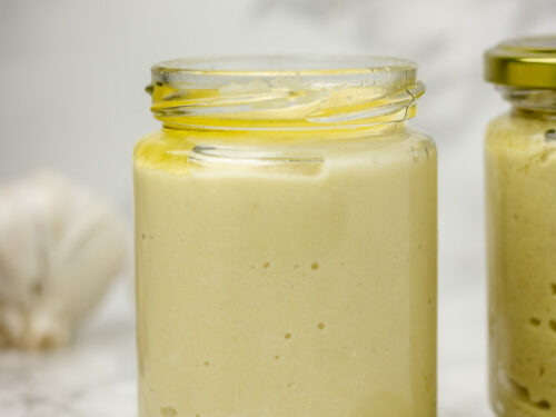 an open jar with creamy paste in it.