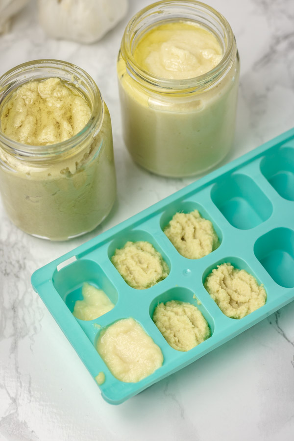 two jars of condiments with some spooned in ice tray.