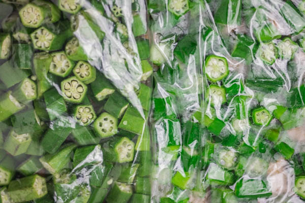 two bags of okra placed beside each other.