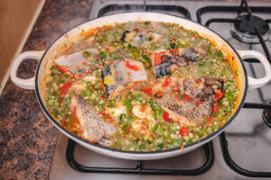 pot of okra soup and fish on the stove top.