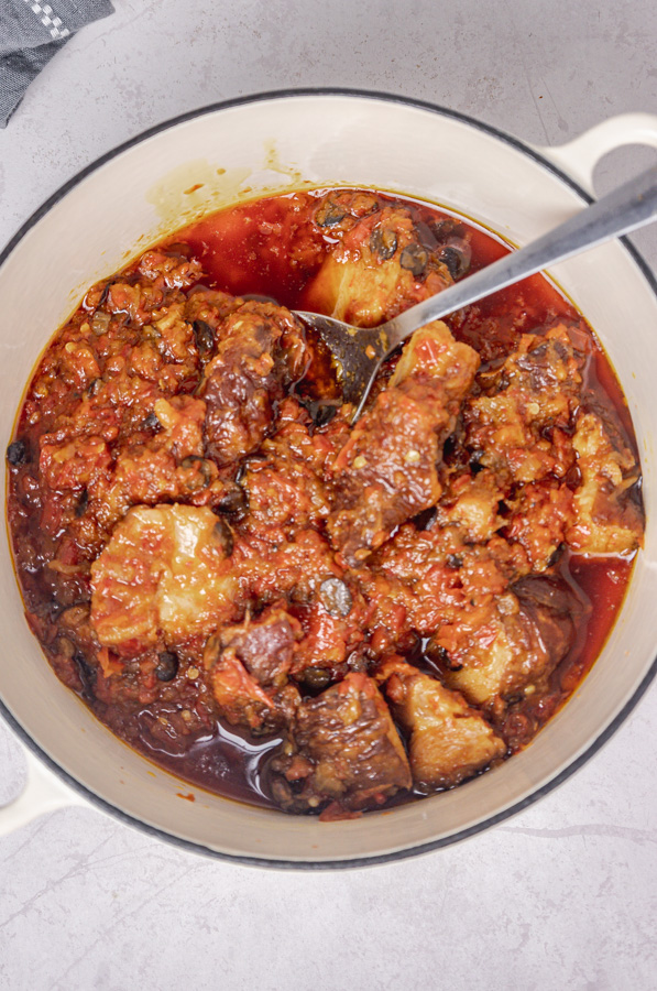 a ladle in a pot of fried stew.