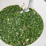 a plate of ewedu soup with a spoon.