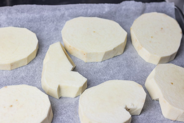 yam slices on a lined baking sheet.